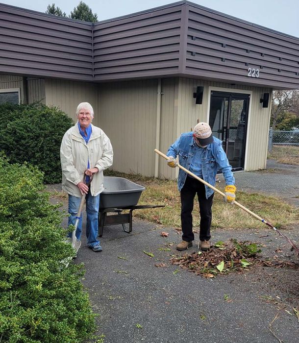 two volunteers at Parksville Community Centre raking leaves